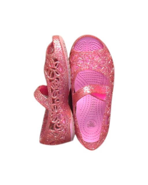 A Pink Flats from Crocs in size 4T for girl. (Front View)