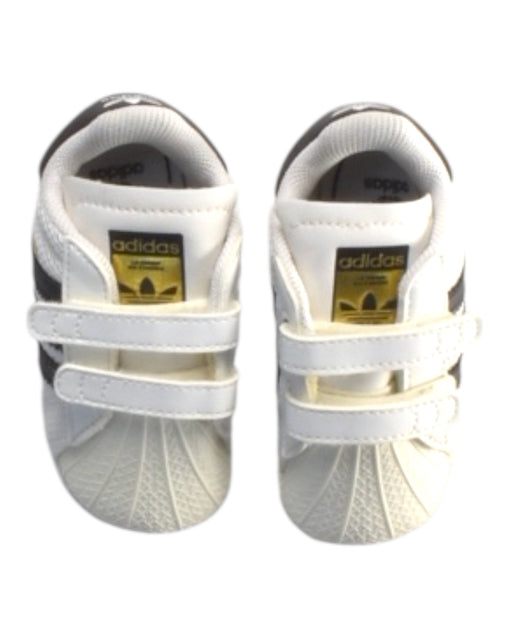A White Sneakers from Adidas in size 6-12M for boy. (Front View)