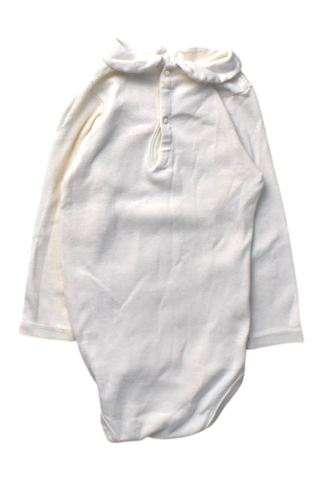 A White Long Sleeve Bodysuits from Petit Bateau in size 12-18M for girl. (Front View)