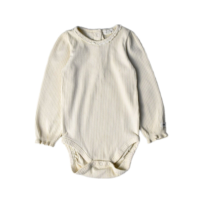 A Ivory Long Sleeve Bodysuits from Newbie in size 12-18M for girl. (Front View)