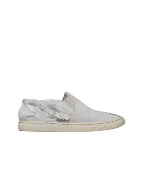 A White Slip Ons from Charles & Keith in size 6T for girl. (Front View)