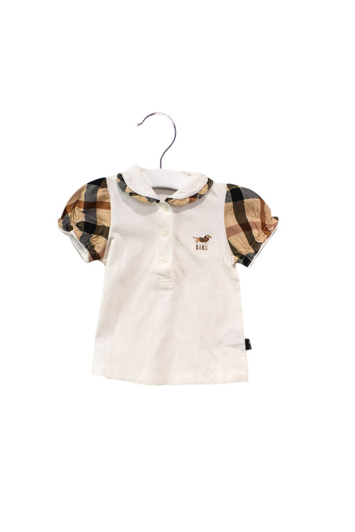 A White Short Sleeve Polos from Daks in size 12-18M for girl. (Front View)
