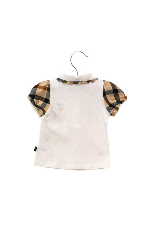 A White Short Sleeve Polos from Daks in size 12-18M for girl. (Front View)