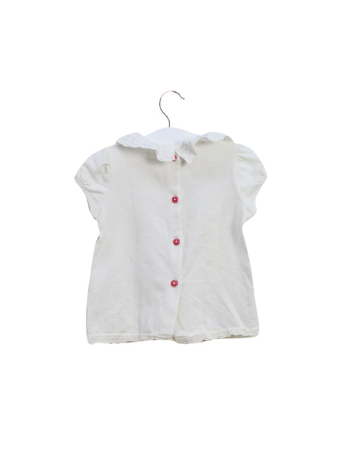A Ivory Short Sleeve Tops from Nanos in size 6-12M for girl. (Front View)