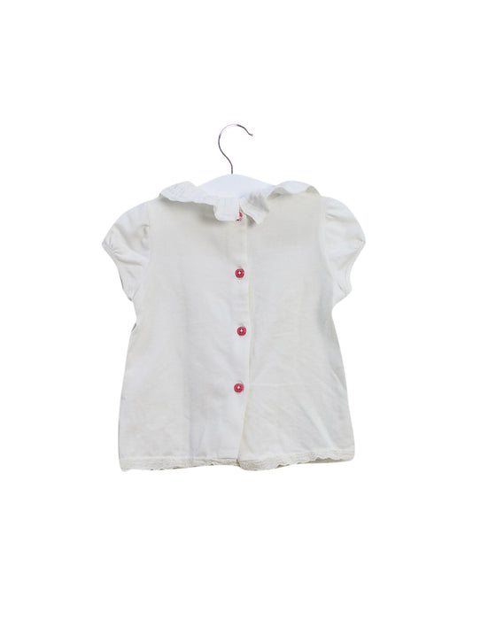 A Ivory Short Sleeve Tops from Nanos in size 6-12M for girl. (Front View)