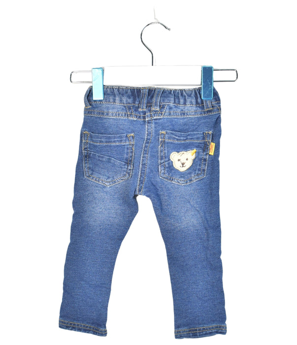 A Blue Jeans from Steiff in size 6-12M for neutral. (Back View)