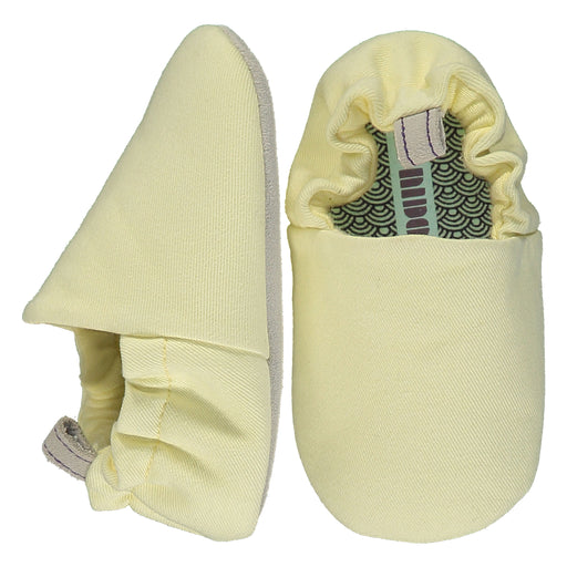A Yellow Slip Ons from Poco Nido in size 18-24M for neutral. (Front View)